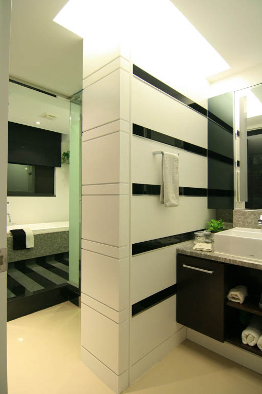 浴室以黑白石材为主调，黑石材带状之墙面分割引导视觉焦点，空间尺寸感大增，银色饰带增加时尚风格。