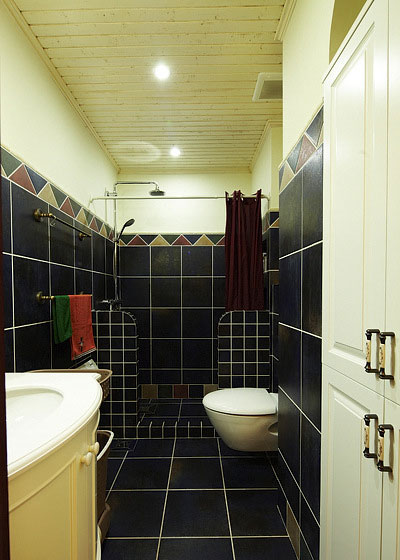 卫生间采用黑色的瓷砖铺饰，配上洁白的卫浴，黑白搭配很是和谐。